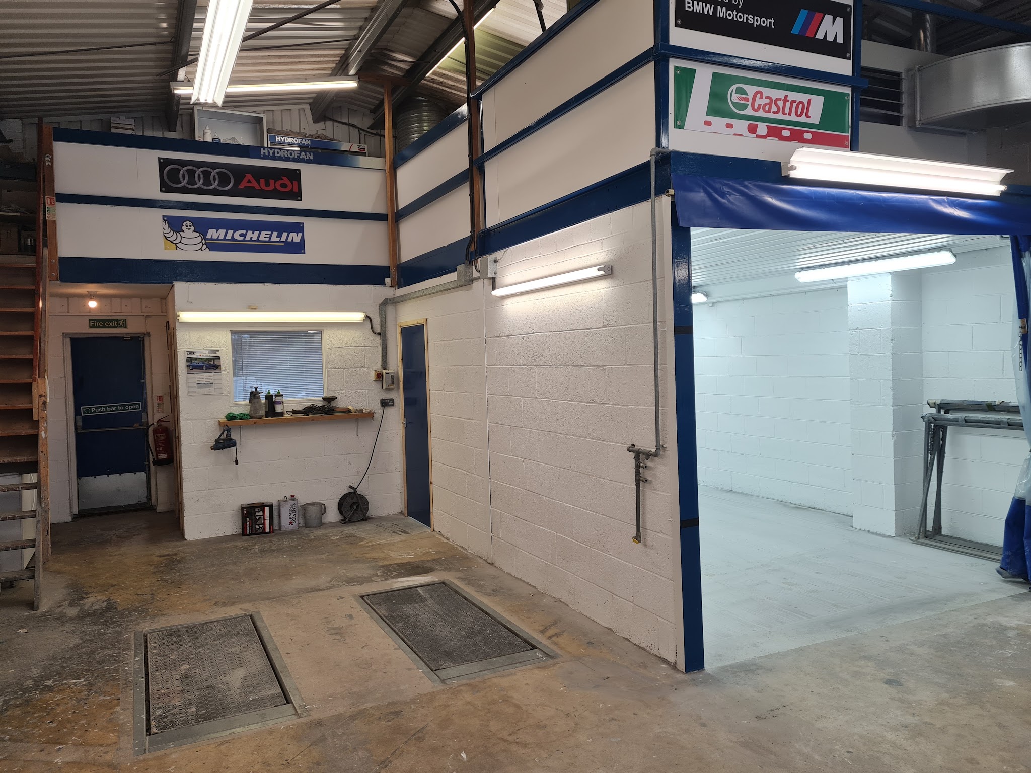 Inside the unit: the office door, the floor pits and the entrance to the spray booth