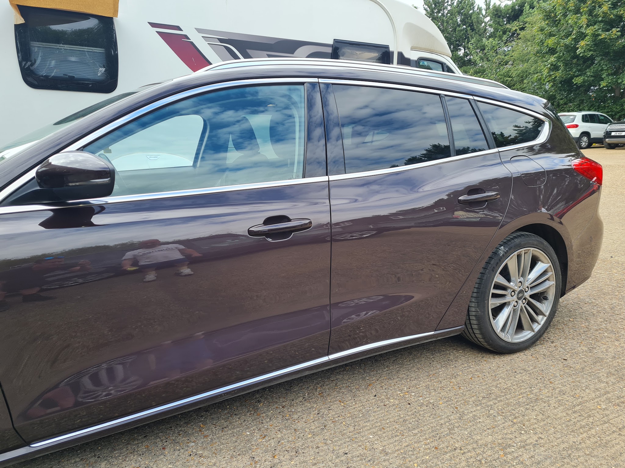 Dark purple Ford Focus estate, finished and parked outside the unit