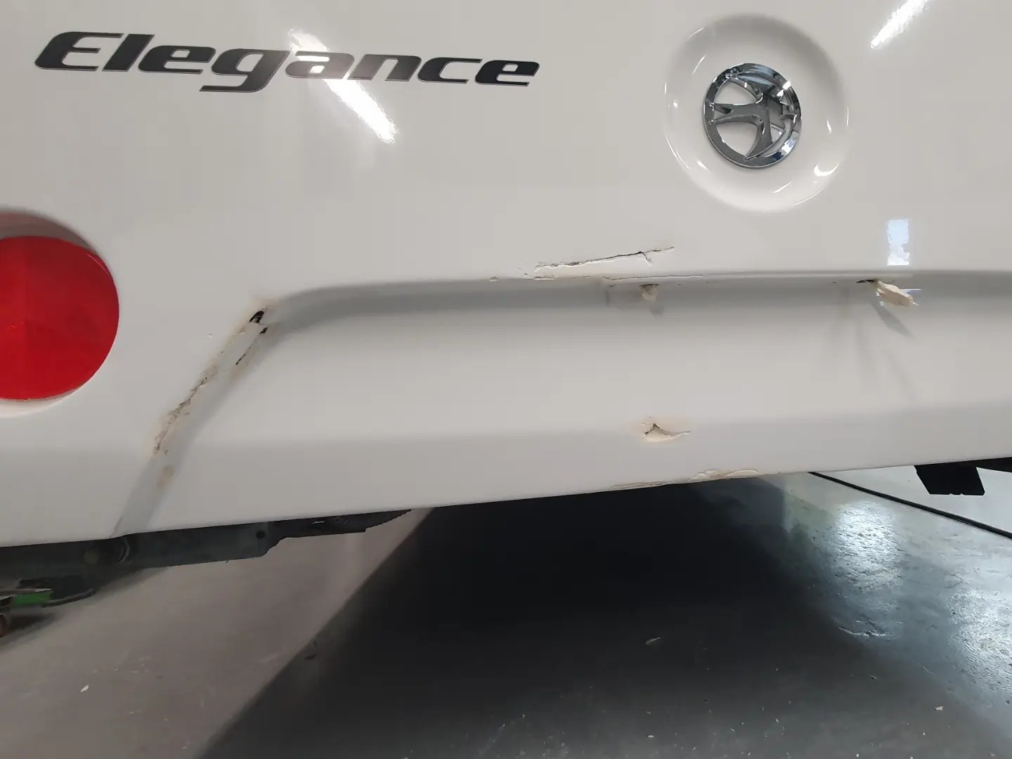 Cracked lower rear panel on a white caravan